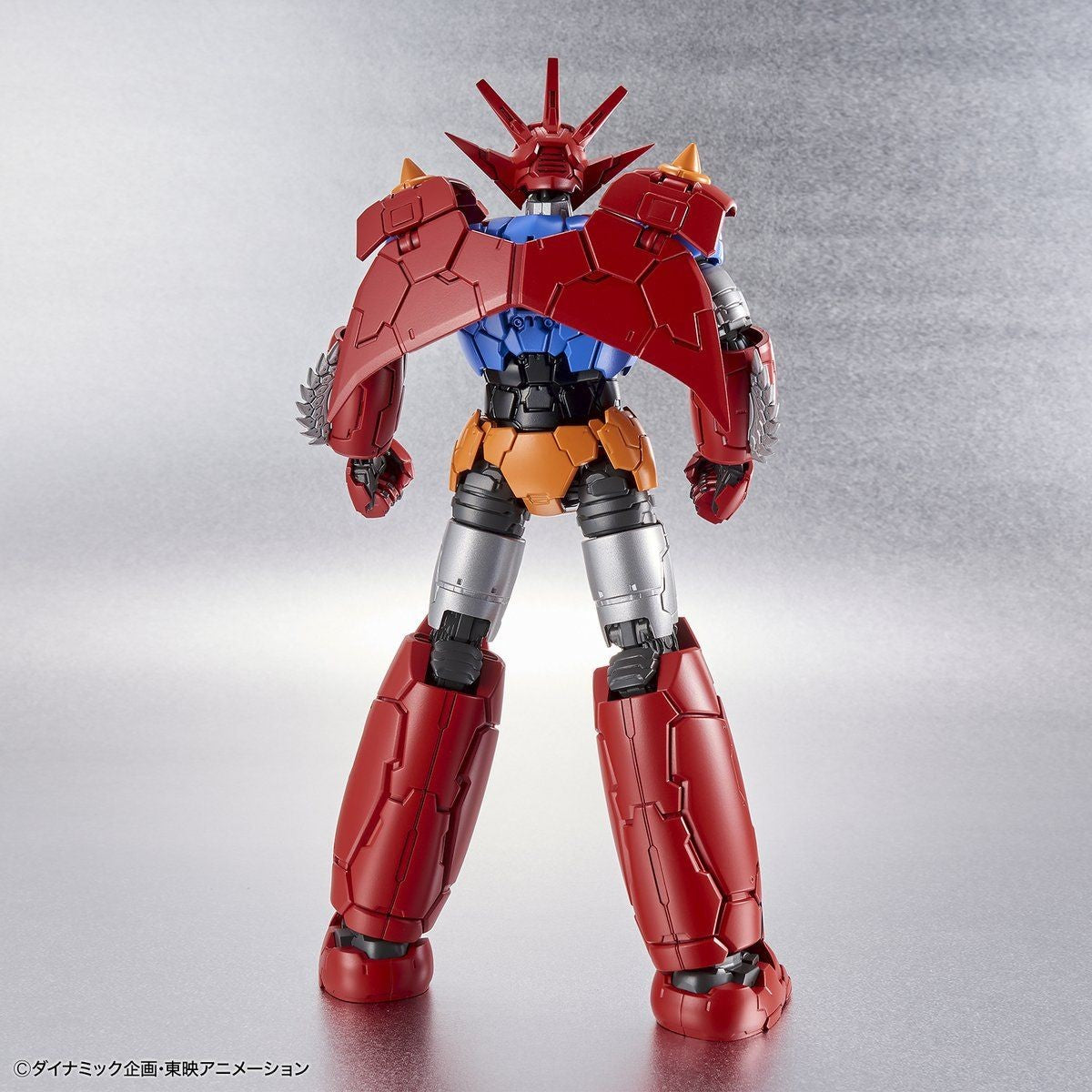 Back view of a red, blue, and silver Getter Robo action figure with mechanical armor and spiked head crest.