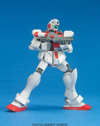 White and red Gundam action figure holding a rifle against a solid blue background.