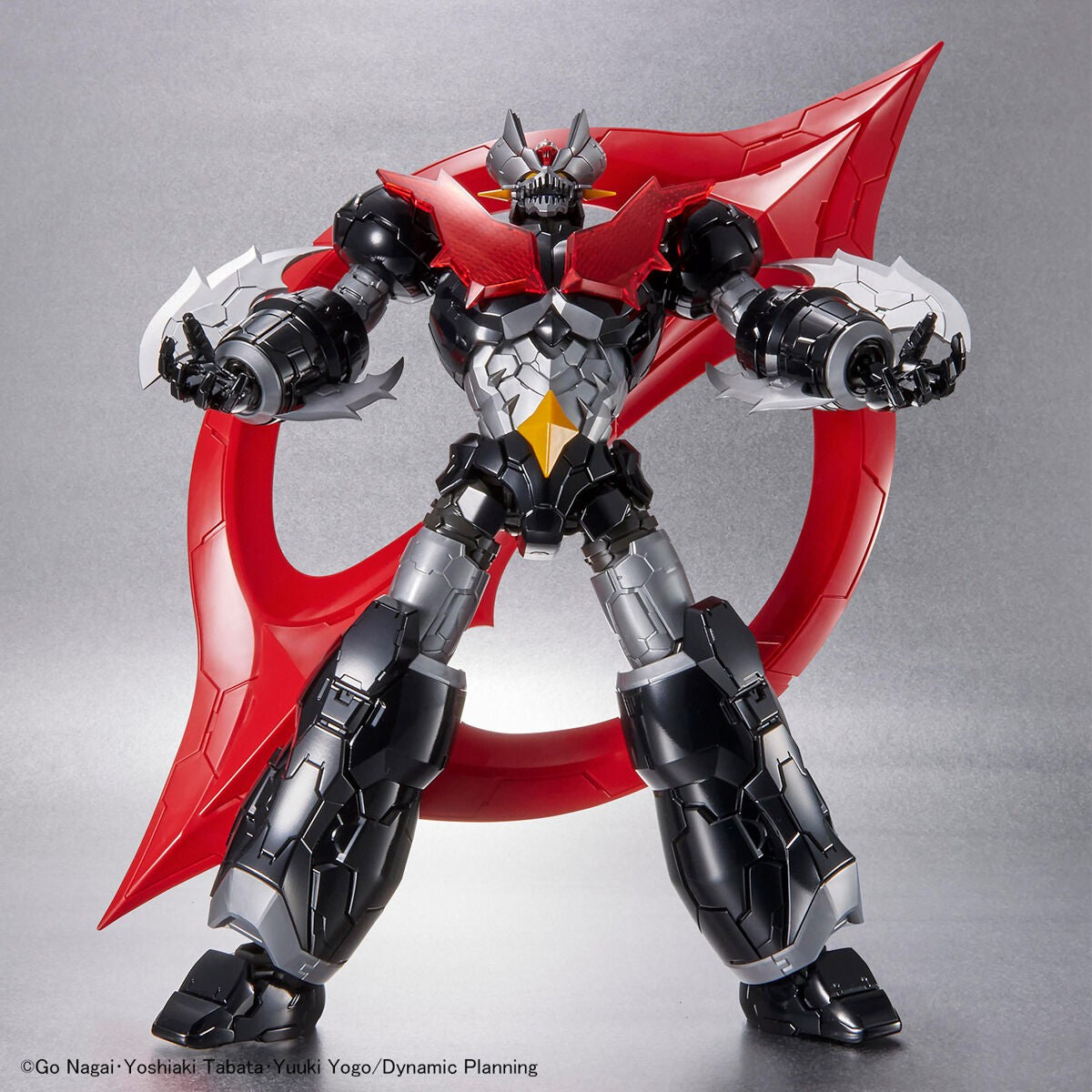 Mazinger Zero action figure: a black and silver robot with a menacing face, red chest plate, and large red wing accessory.