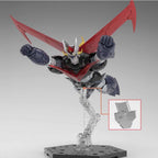 Mazinger Z model kit in black, silver, and red, posed flying on a clear display stand with an inset detail view.