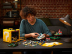 Persona costruisce il set LEGO Super Mario 71395 Blocco Punto Interrogativo con mini-livelli di Super Mario 64.