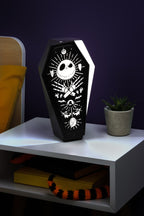 The Nightmare Before Christmas coffin-shaped LED lamp with white character designs on a black background.