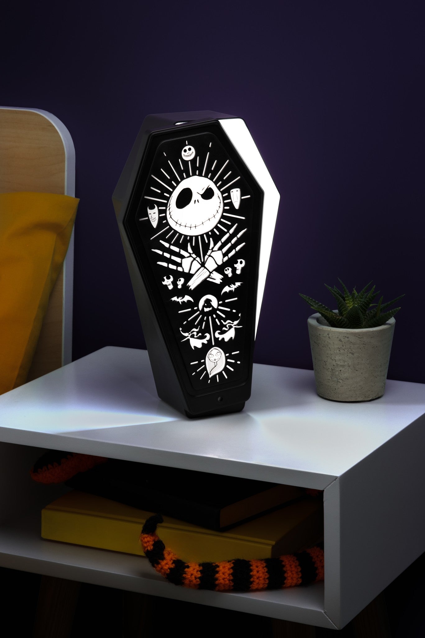 The Nightmare Before Christmas coffin-shaped LED lamp with white character designs on a black background.