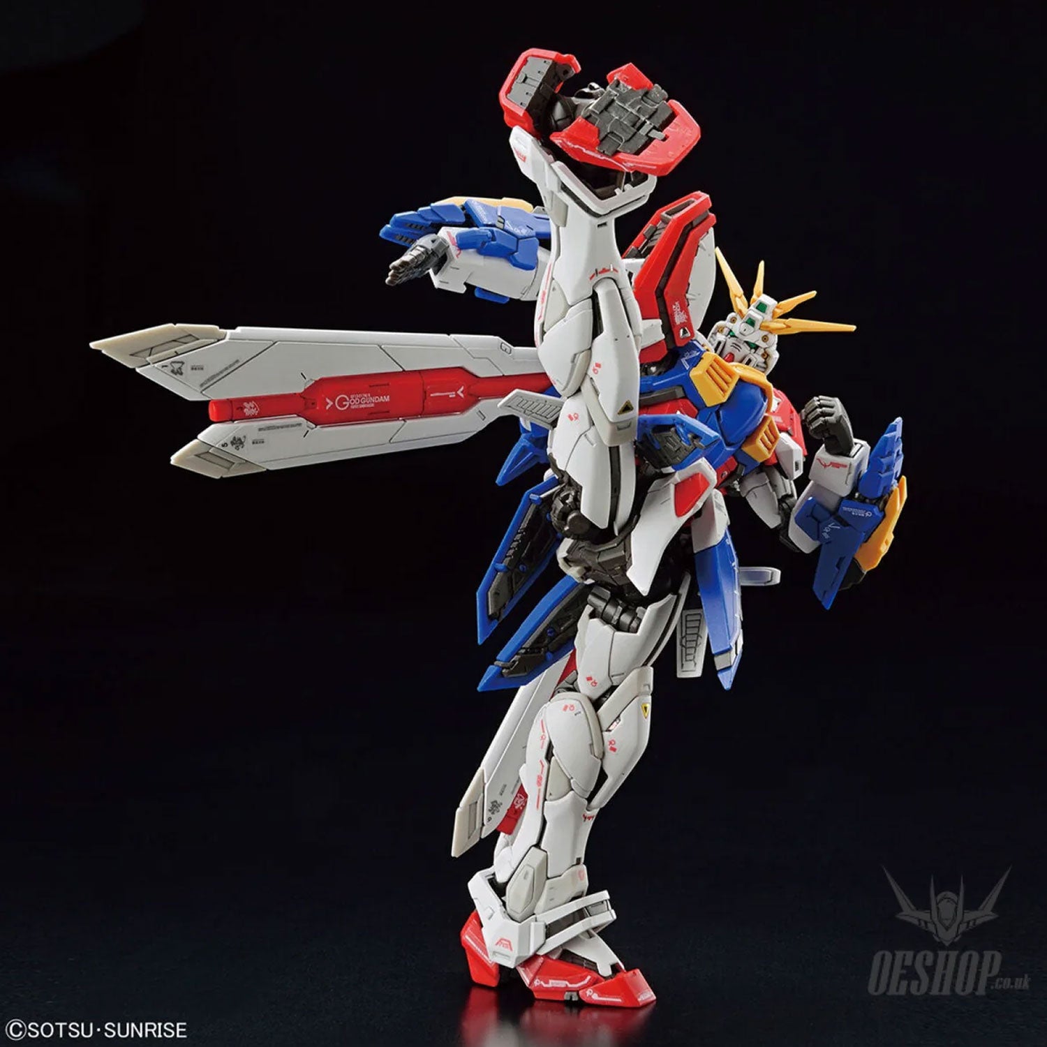 God Gundam action figure, white, red, blue, and yellow with high-articulation pose, isolated on black background.