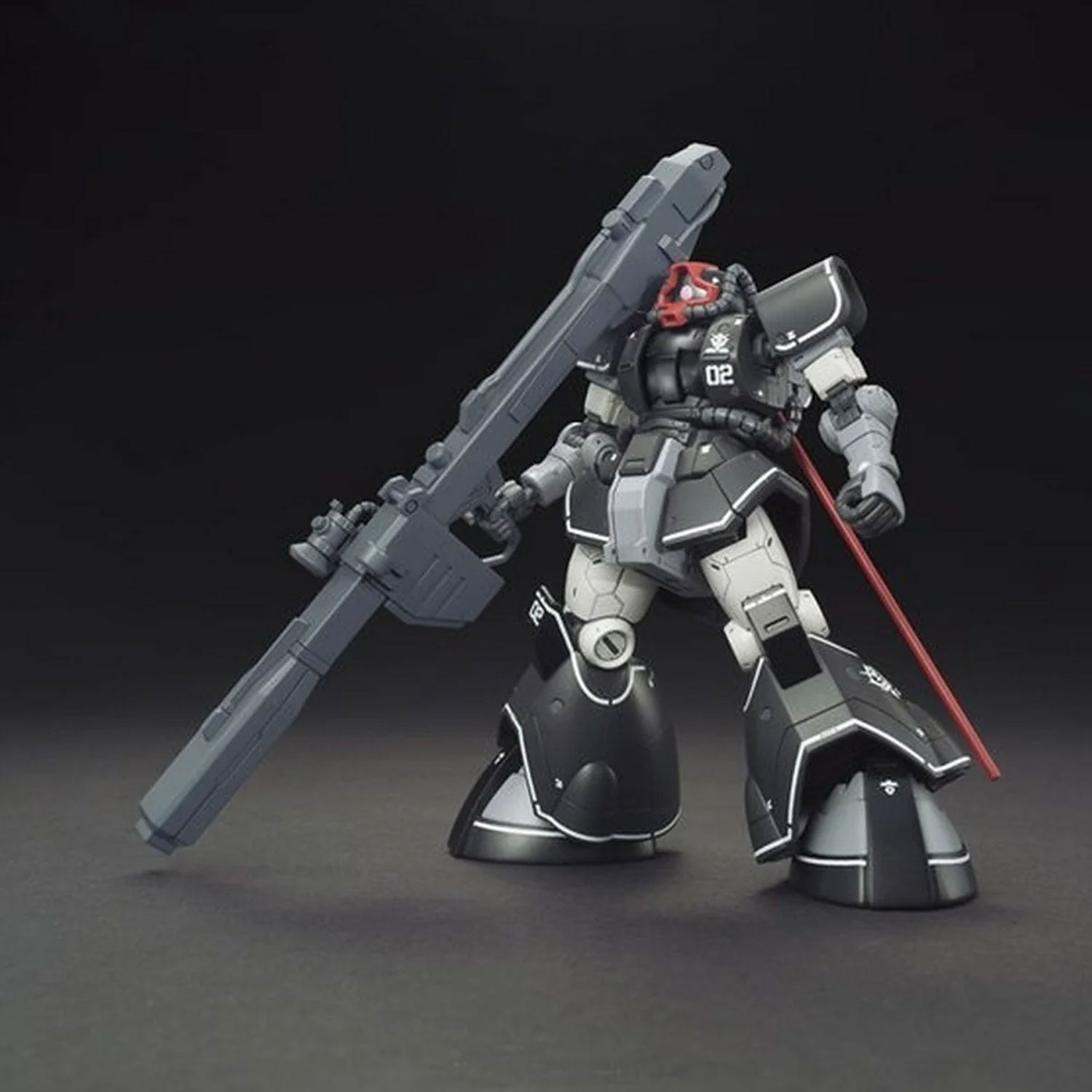 Black and grey Gundam plastic model kit with a large cannon and red visor, posed against a dark background.