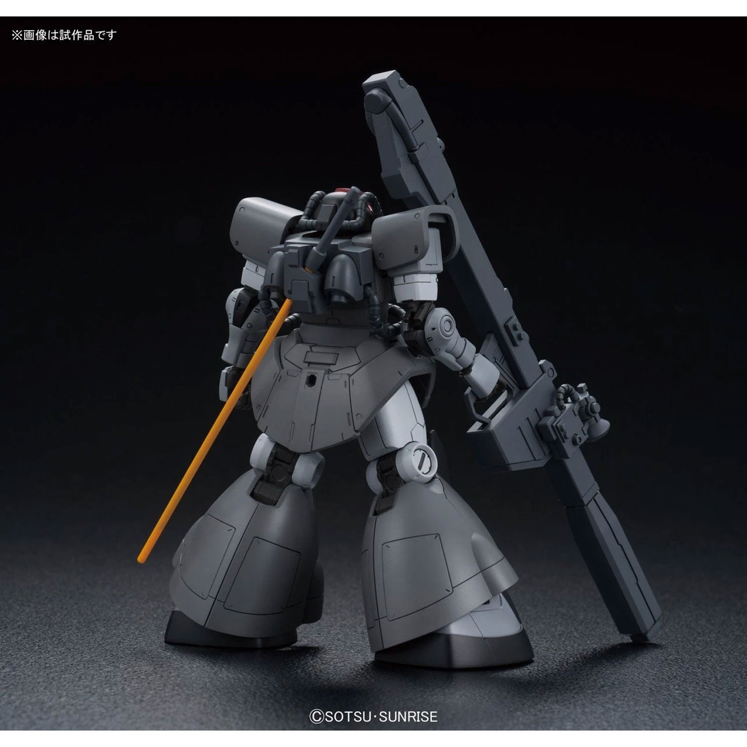 Back view of a grey Gundam model kit holding a large rifle, featuring a yellow beam saber hilt on its backpack.