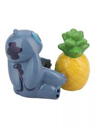Blue Stitch figurine sitting next to a bright yellow pineapple with green leaves, glossy cartoon-style design.
