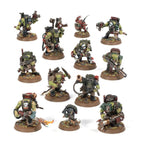 A set of Warhammer 40k Ork Kommandos miniatures, painted in green with detailed weapons, gear, and rocky bases.