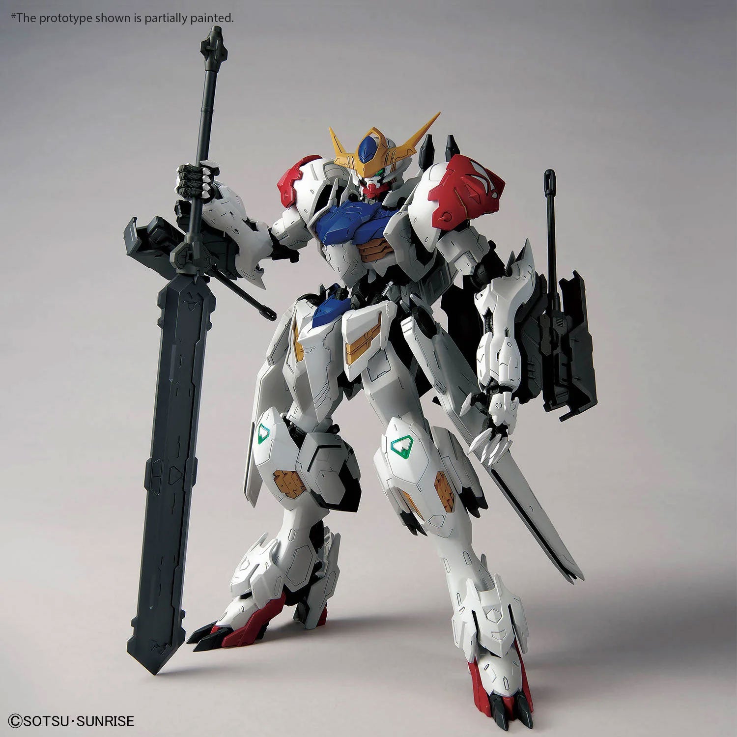 Gundam Barbatos Lupus Rex model kit with white, blue, and red armor, holding a large grey sword on a grey background.