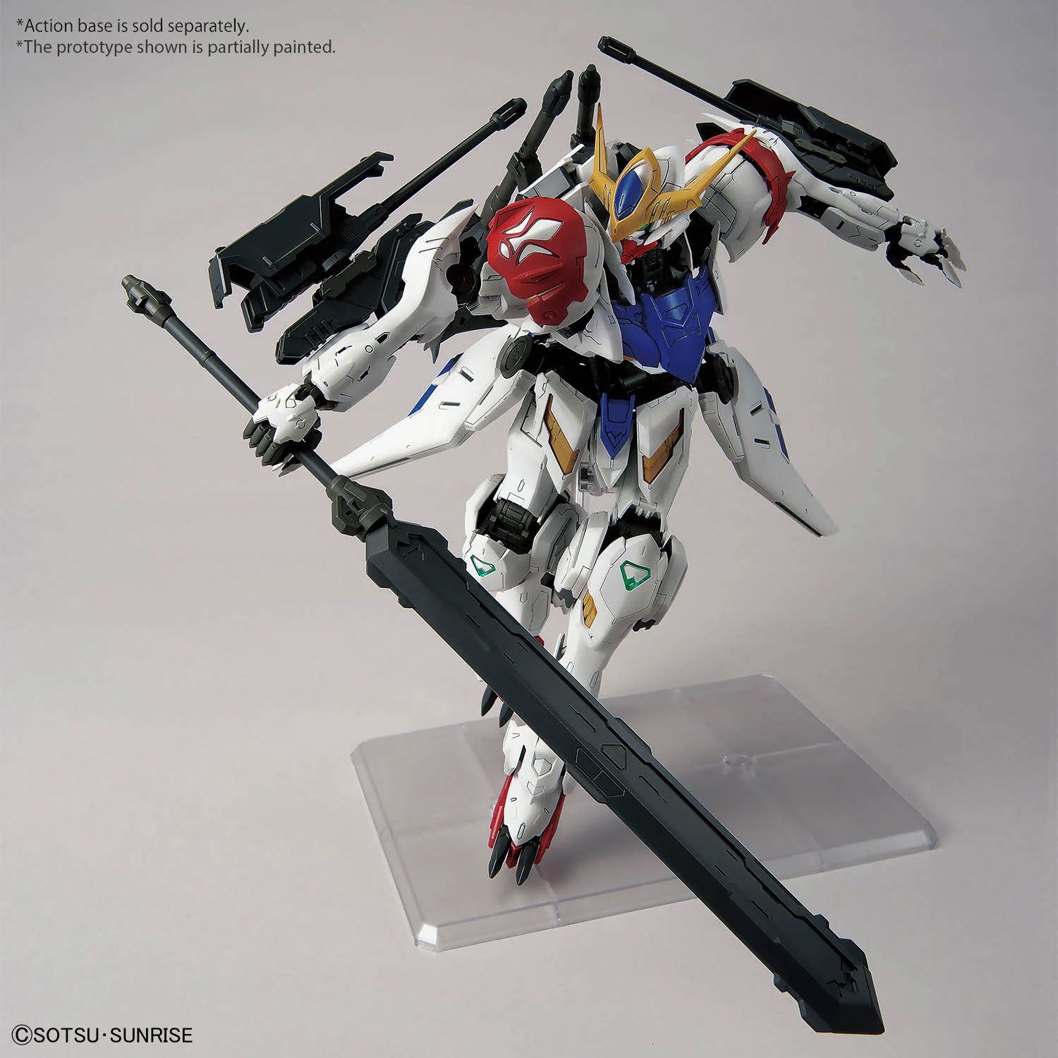 Gundam model kit in white, red, and blue with a large black sword and backpack thrusters in a dynamic combat pose.