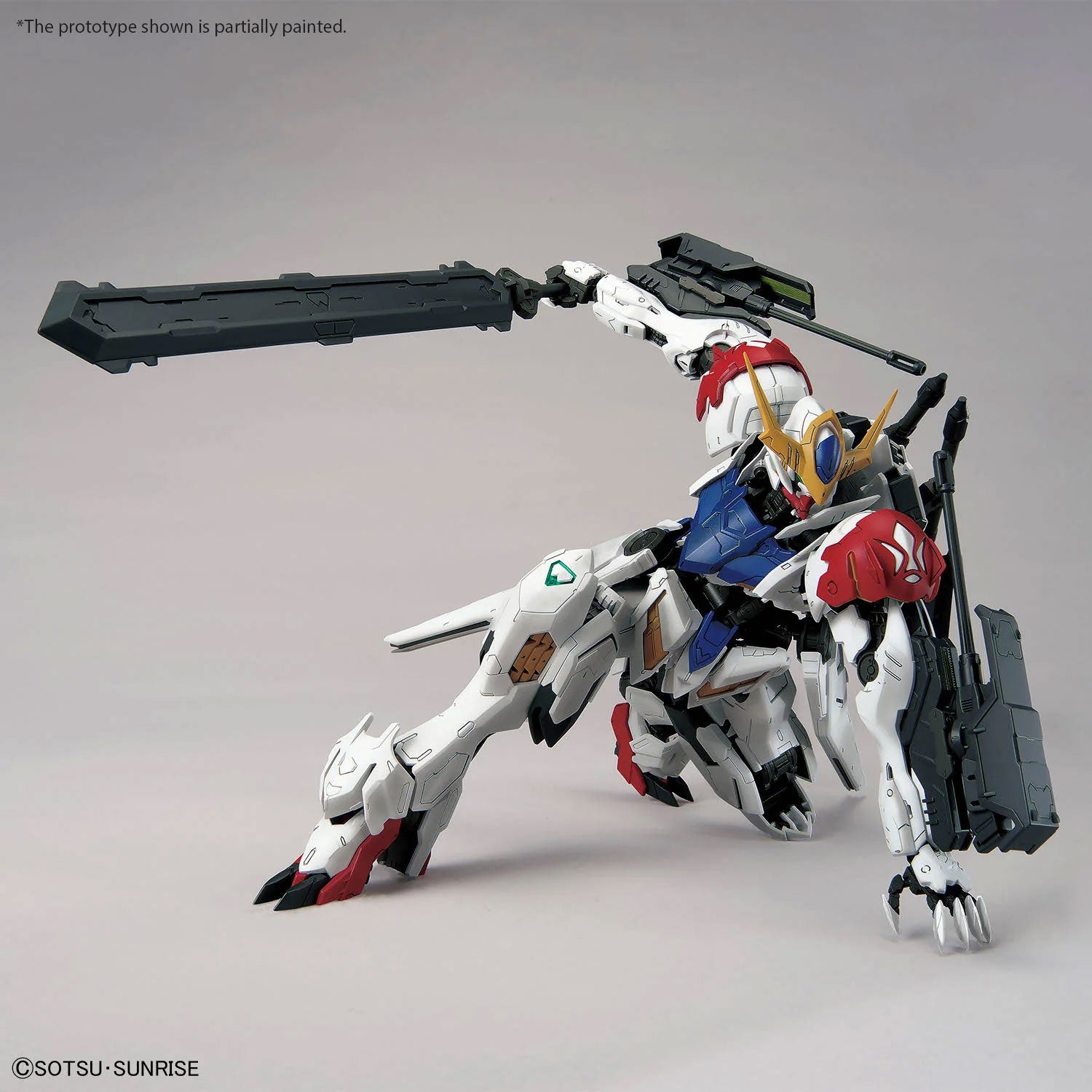 Gundam Barbatos Lupus Rex model kit in a dynamic crouching pose, featuring white, red, and blue armor with a giant sword.
