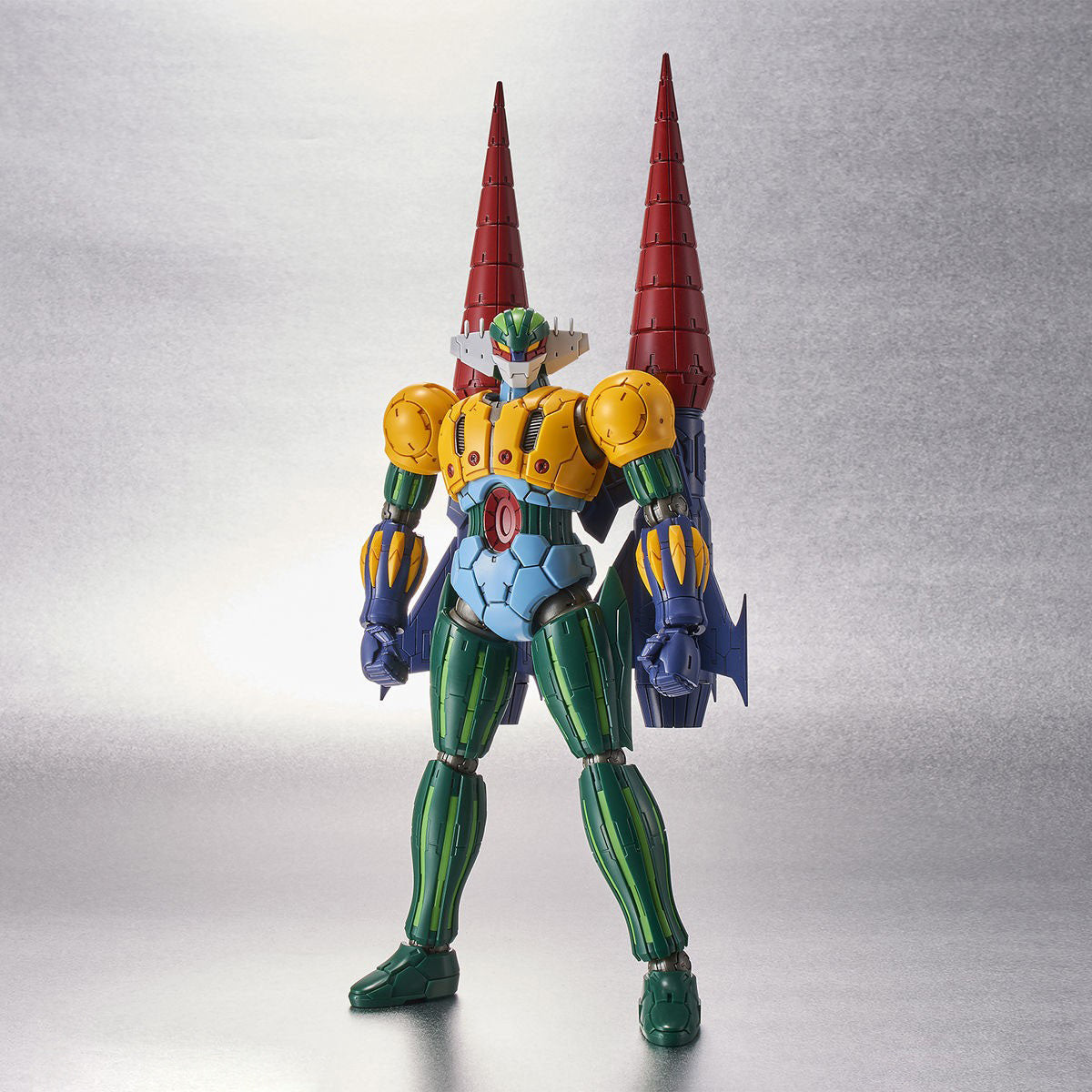 Getter Robo action figure featuring green, yellow, and blue armor with two tall, red drill-like spikes on its back.