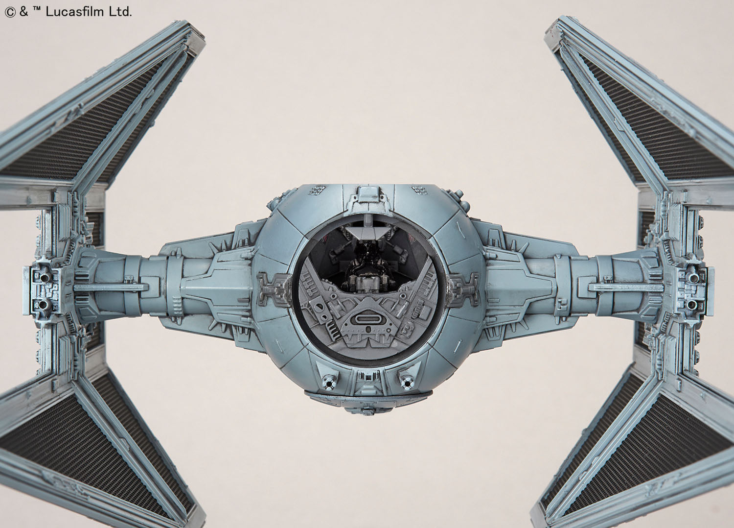 Front view of a grey Star Wars TIE fighter model with a detailed cockpit and angular solar array wings.