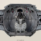 A detailed grey TIE fighter cockpit model with a black pilot figure at the controls.